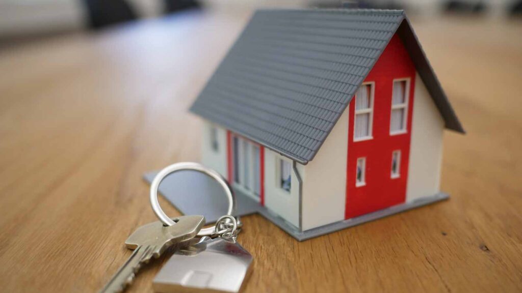 A tiny model home with a set of keys