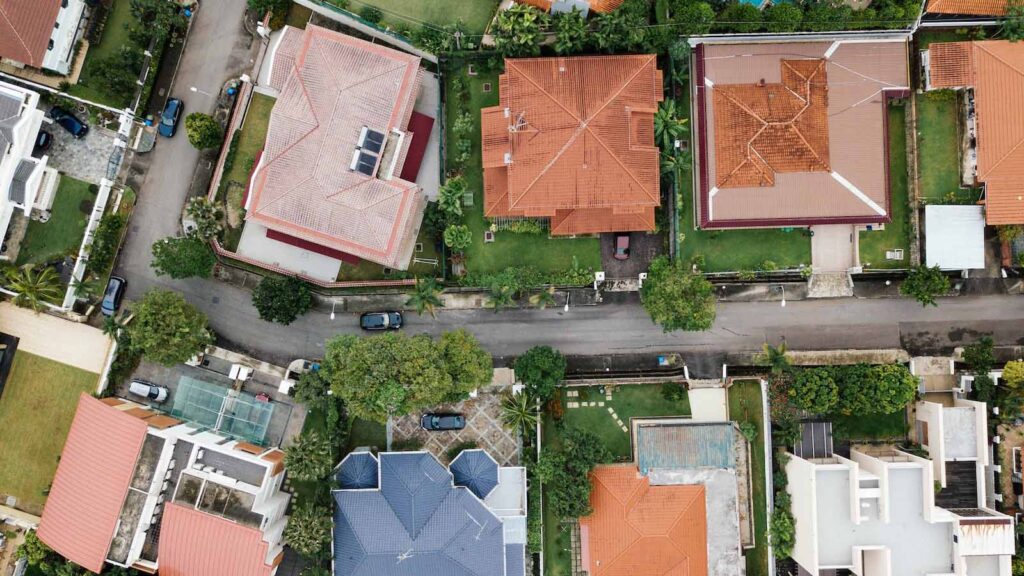 A drone shot of an upscale neighborhood that would be marketed and sold through a real estate franchise