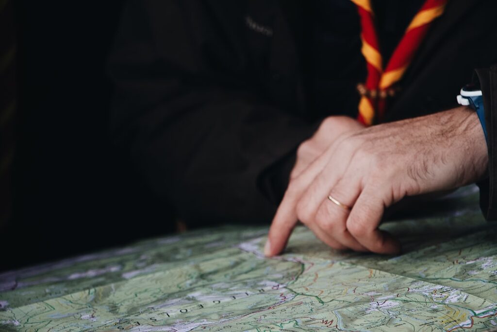 Person's hand touching a glowing, futuristic digital interface displaying a map of a city, symbolizing AI-driven real esta...