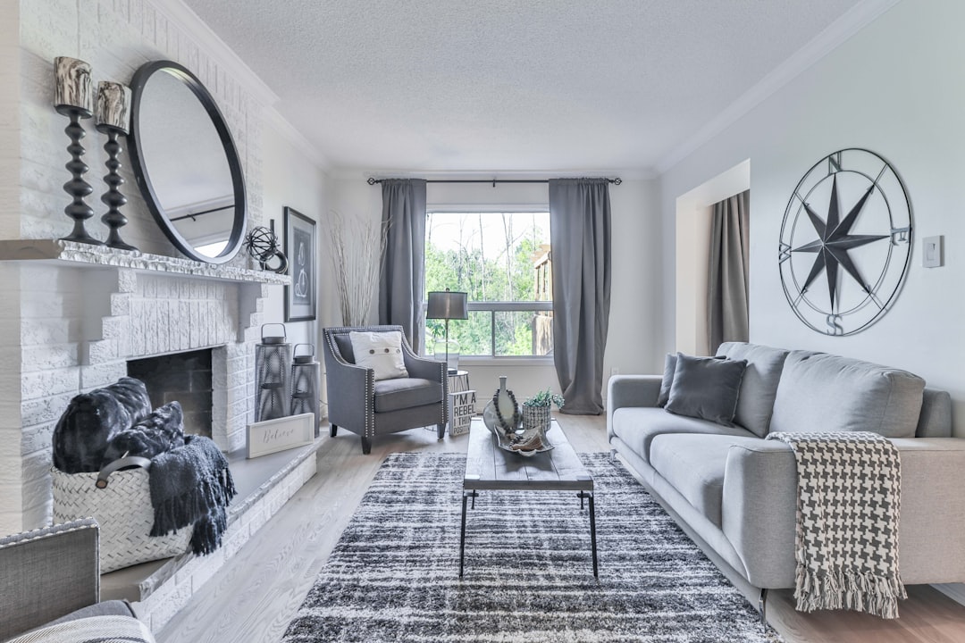 A sleek, modern living room with a glowing digital grid overlay, illustrating the concept of augmented reality and immersive virtual home tours in real estate.