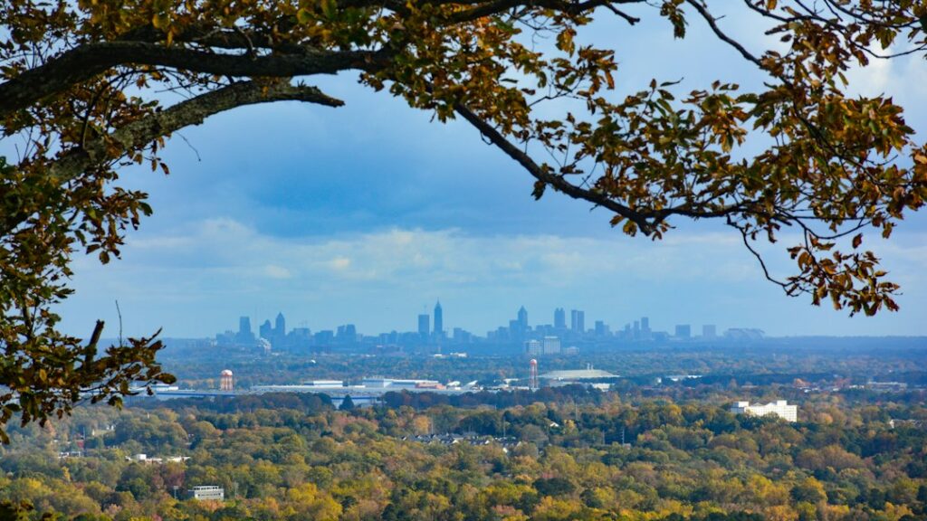 Bright, professional photograph of the modern Atlanta skyline, representing the city's dynamic real estate market.