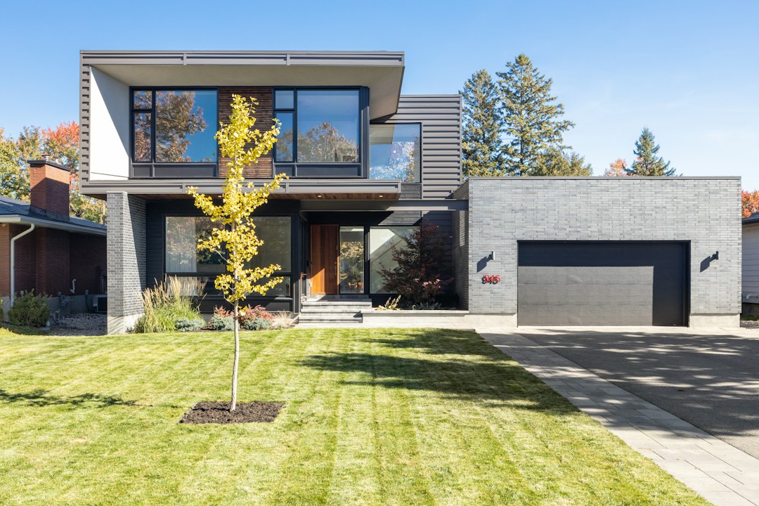 A side-by-side view of a modern home and a traditional brick house, illustrating the choice between different real estate models.